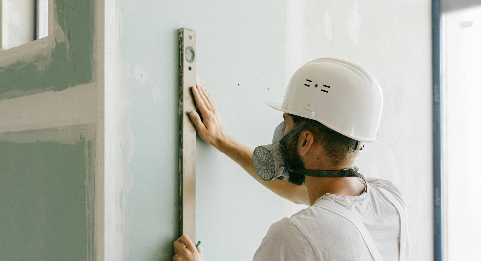 mężczyzna mierzy karton-gips